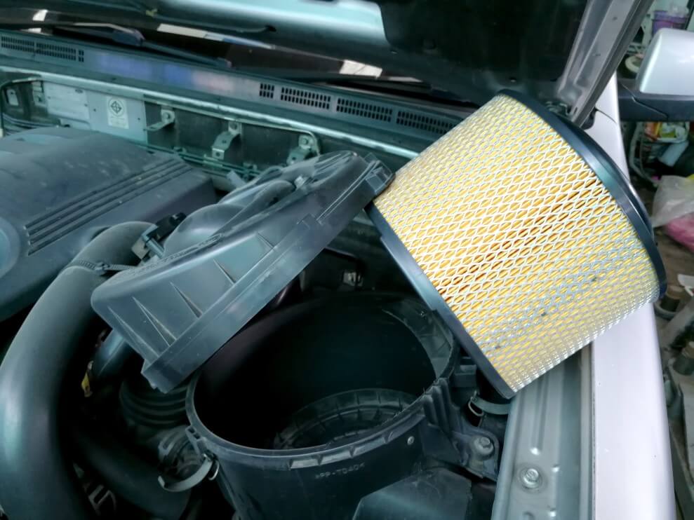 New air filter being installed in car