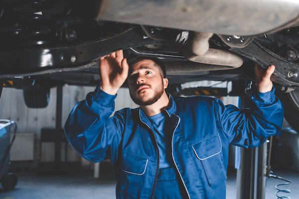auto mechanic inspects car